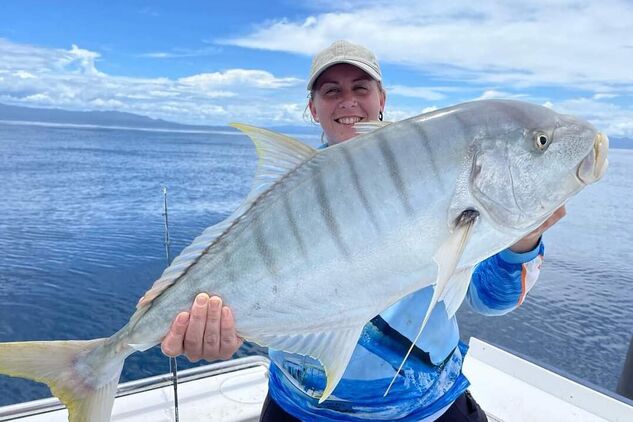 Angler holding up a freshly caught Giant trevally