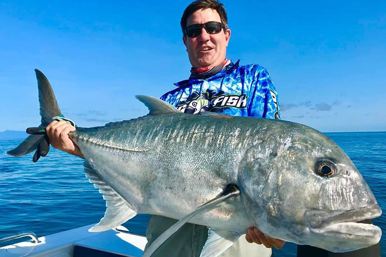 Angler showing a freshly caught Giant trevally
